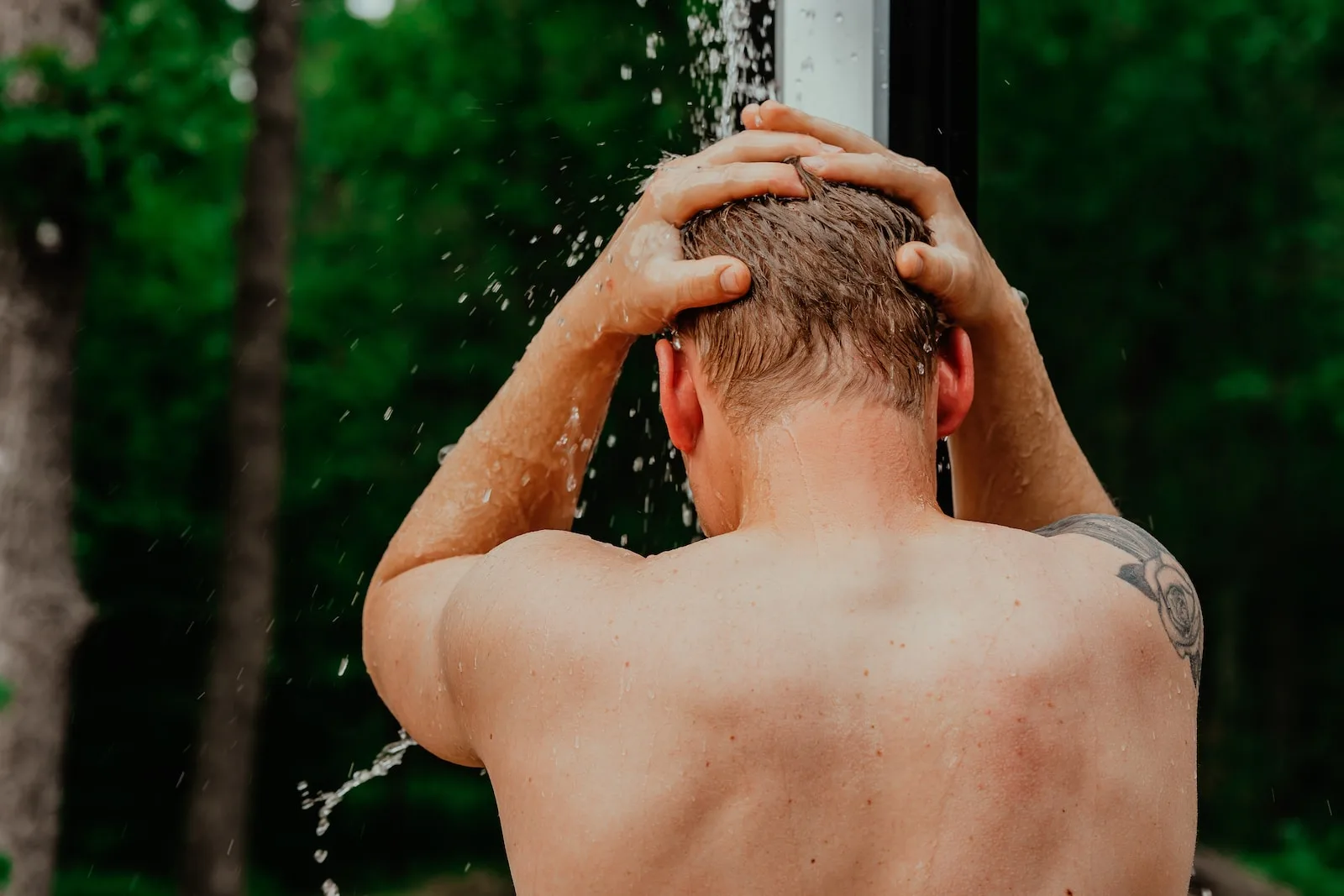 A Person With The Hands On The Head Enjoying The Hot Water From Their Water Heater